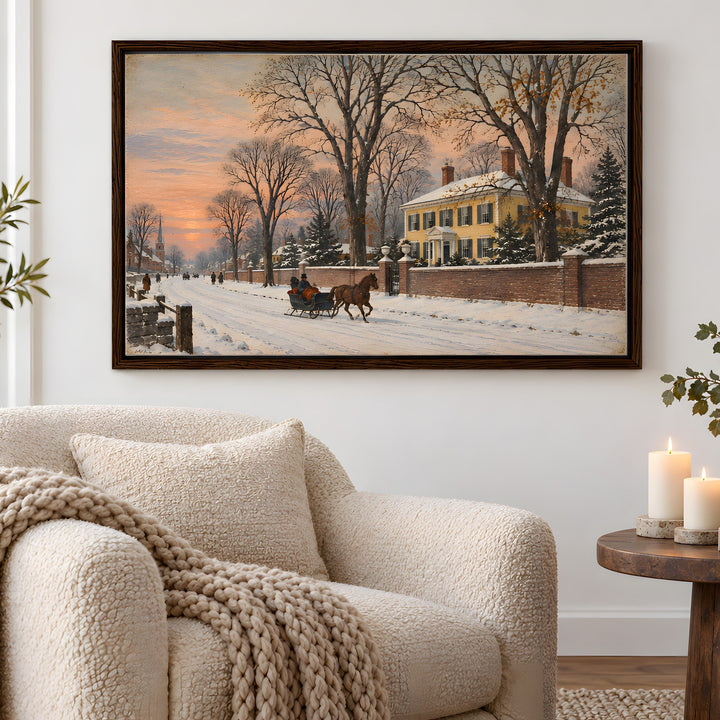 A framed winter landscape painting hangs on a white wall above a cream bouclé armchair in a styled living room. The painting depicts a snowy street at sunset with bare trees, a yellow house, and a horse-drawn carriage.