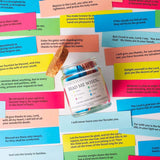Color-coded Bible verse cards spread around the open cork jar
