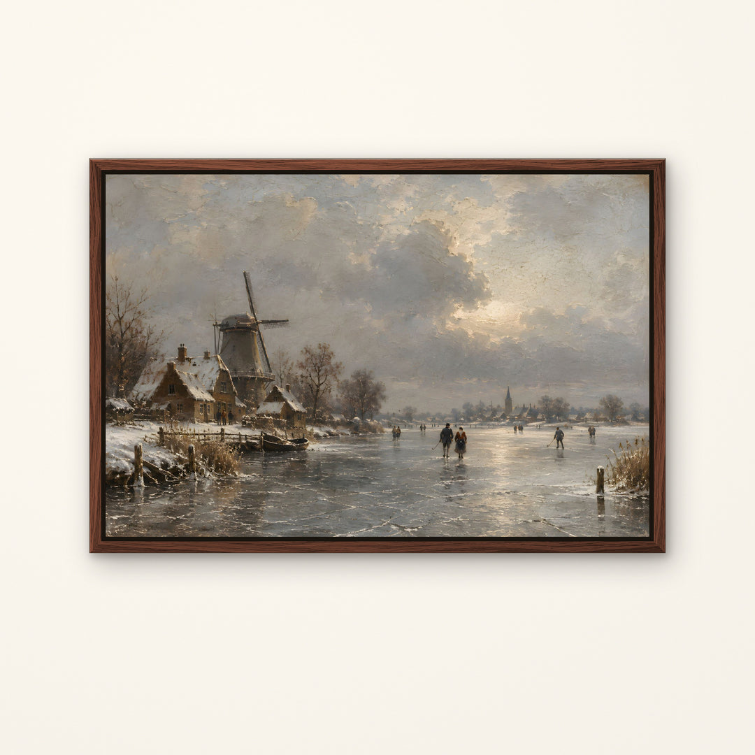 A framed landscape painting of a snowy winter scene with a windmill, small houses, and people skating on a frozen river under a cloudy sky, displayed against a light beige wall.