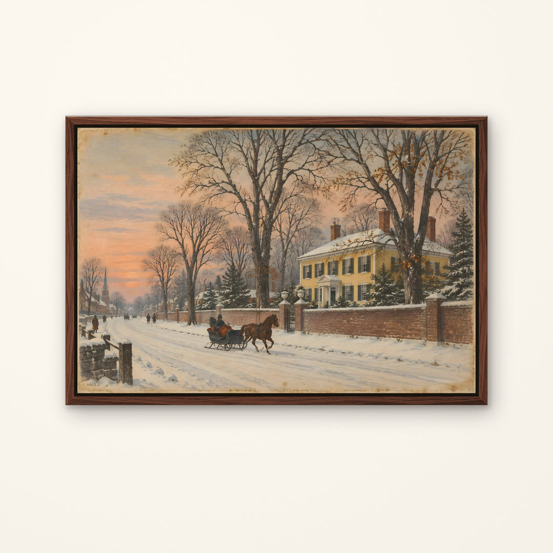 A framed winter landscape painting hanging on a light wall. The artwork shows a snow-covered street with bare trees, a large yellow house, and a horse-drawn carriage under a soft pink and orange sky.