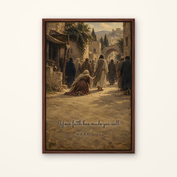 A framed art print featuring a classical painting of a biblical street scene with figures walking past an archway, with the text 'Your faith has made you well' and 'MARK 5:34' at the bottom. The print is housed in a dark brown wooden frame and displayed against a light beige wall.